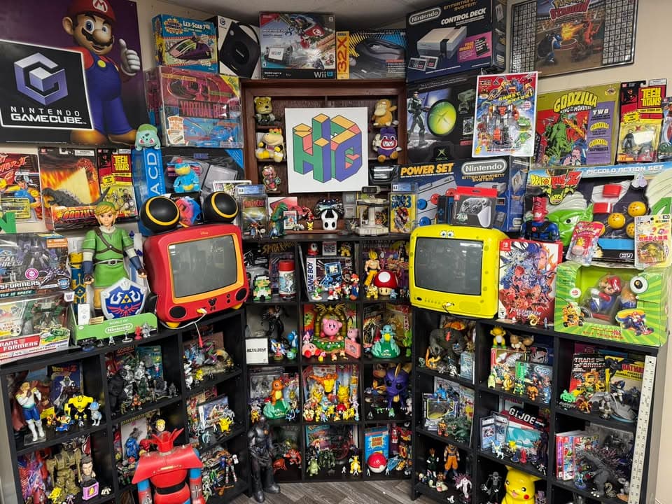 Wall display of retro video games and collectible toys at HC Empire